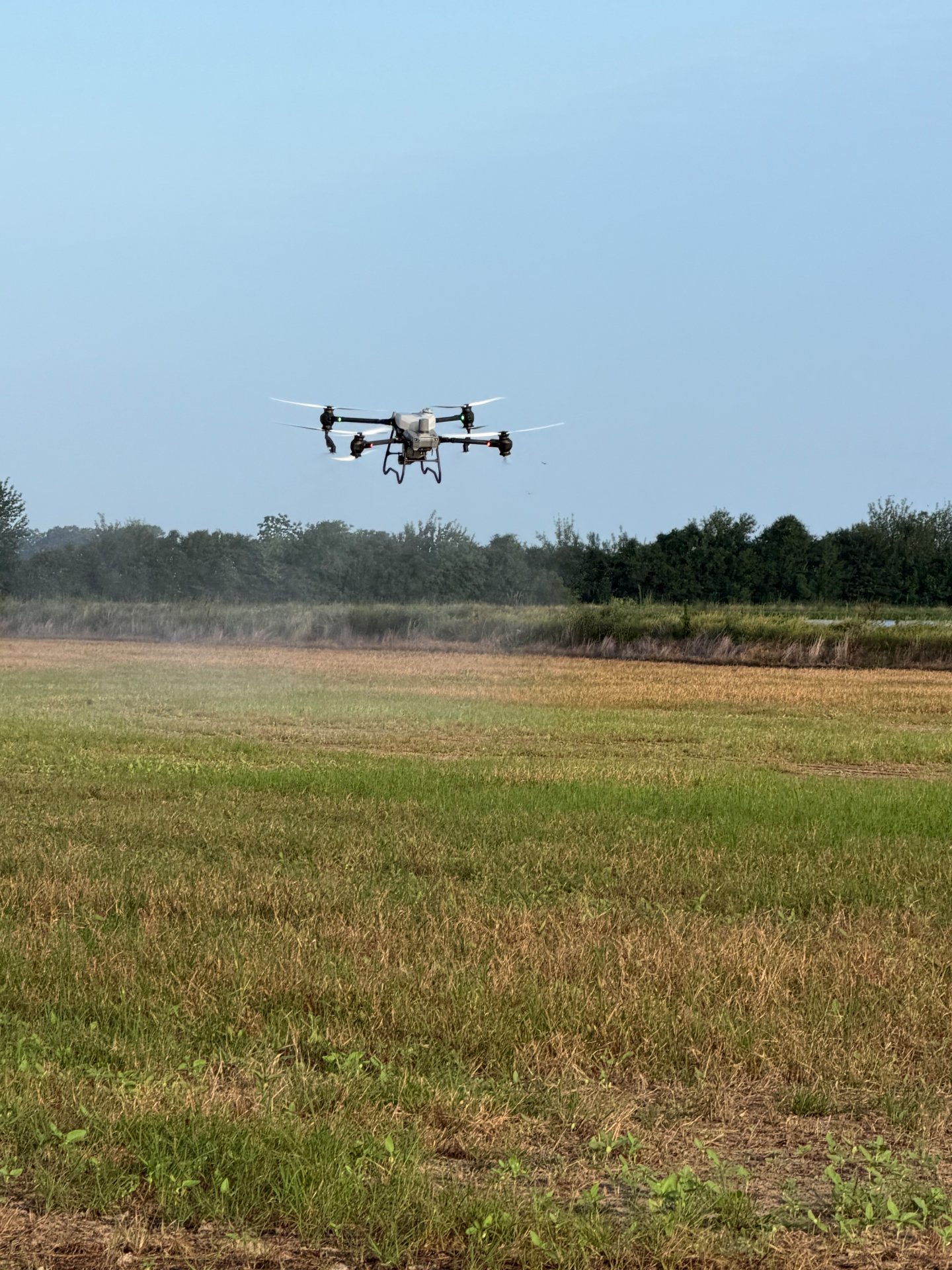 Spray drone flying over a Louisiana rice field
